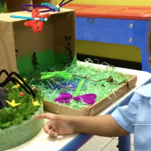 Child pointing at preschool project